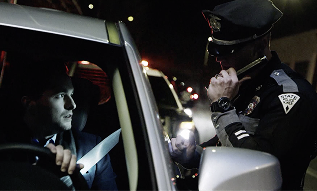 Driver and police officer at DWI checkpoint